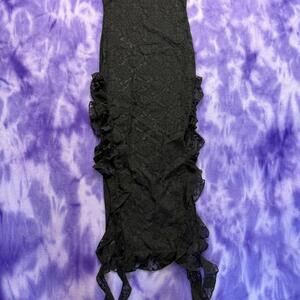 Black lace tube dress with ruffles and side slits.
